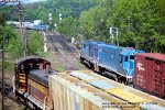 B&M, Boston and Maine GP40 300 leads a eastbound up to the signals as, B&M 201 westbound leaves the yard, and B&M 1223 switches cars. All trains were moving, at East Deerfield, Massachusetts. May 17, 1980. 